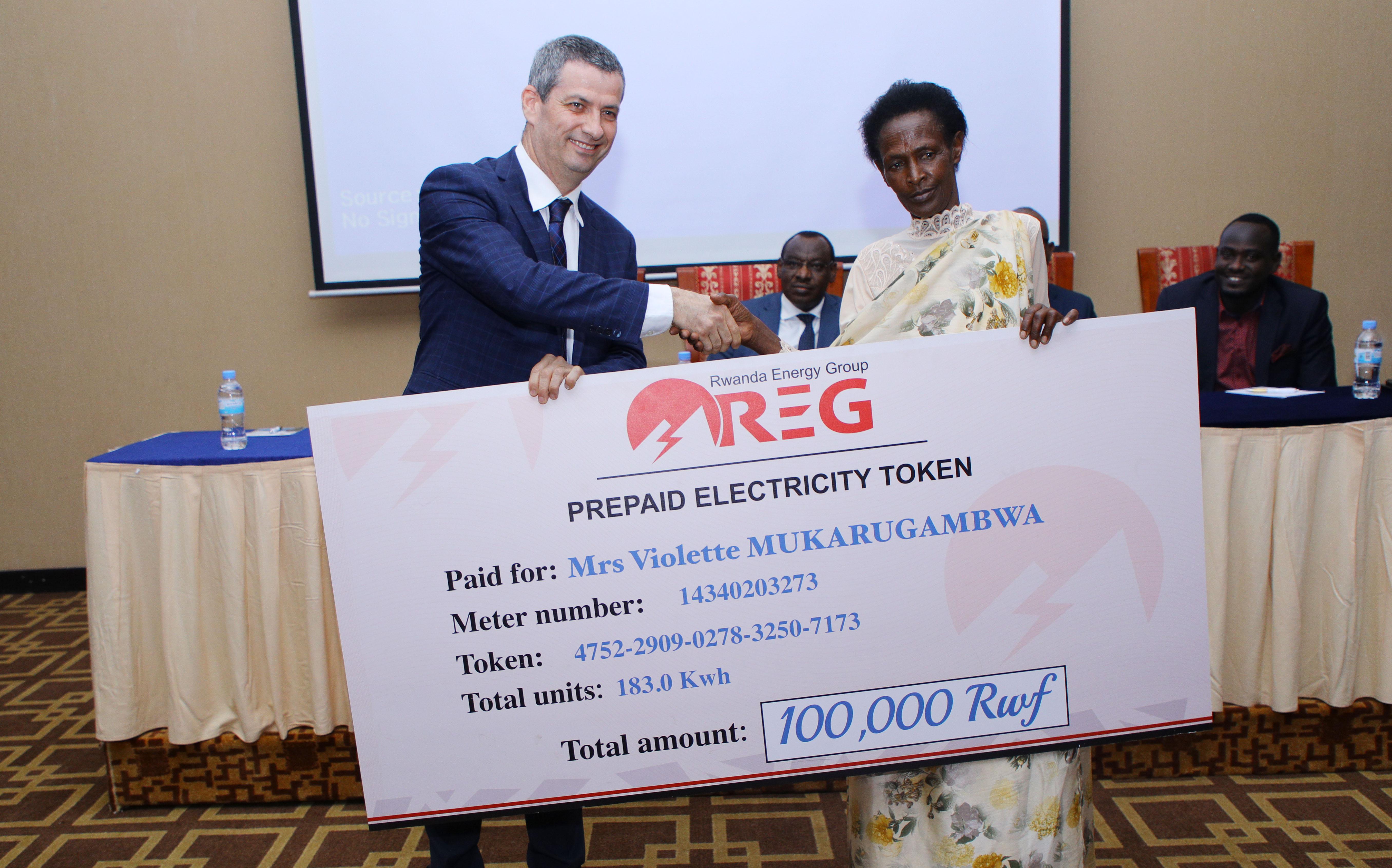 Ron Weiss, the CEO of Rwanda Energy Group (REG) recognized the one millionth customer, Violette Mukankuranga, a resident of Mwulire sector in Rwamagana District (Sam Ngendahimana)