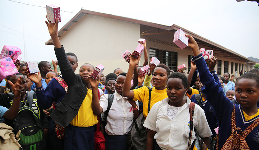 Girls from GS Kagugu receive pads from #FreeThePeriod initiative. (All photos by Craish Bahizi)