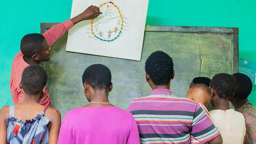 Teenage mothers at Centre Marembo in Gasabo District being taken through the reproductive cycle by a health worker. The centre helps vulnerable teen mothers. 