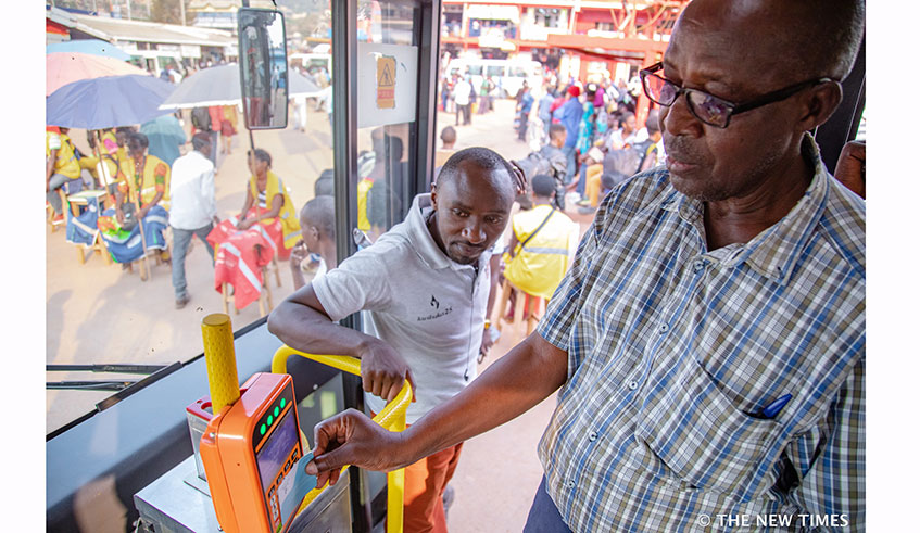 A passenger uses a Tap&Go card to board transport bus in Kigali. Rwanda has continued to make strides in digitalising services.