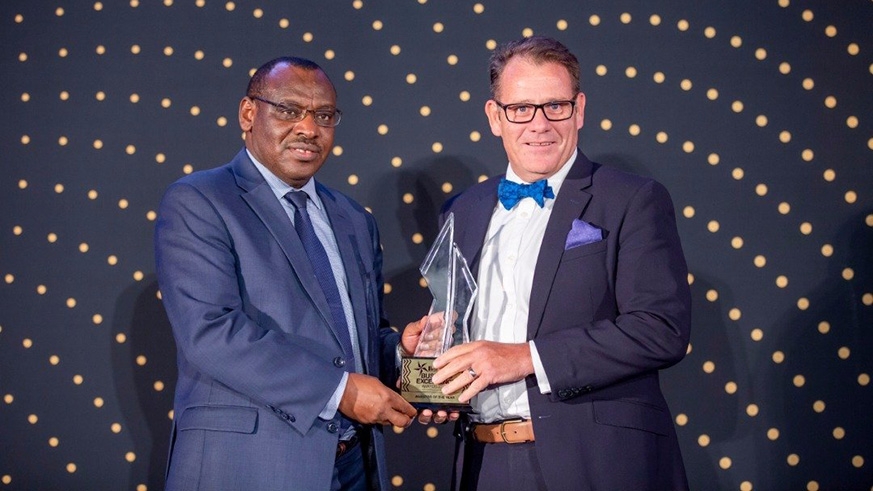 The Managing Director of I&M Bank, Robin Bairstow gets an award from infrastructure minister Claver Gatete  during the Business Excellence Awards last year. The bank was recognised as Investor of the Year. File