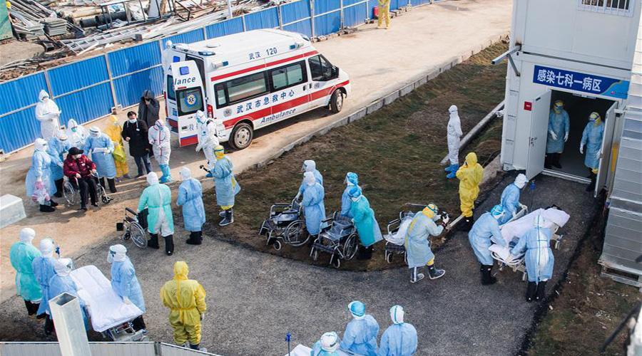 Medical workers help the first batch of patients infected with the novel coronavirus move into their isolation wards at Huoshenshan (Fire God Mountain) Hospital in Wuhan, central China's Hubei Province, Feb. 4, 2020. A newly-built hospital in Wuhan, the epicenter of the novel coronavirus outbreak in China, began accepting patients infected with the virus on Tuesday. The first batch of patients are being transferred to Huoshenshan (Fire God Mountain) Hospital, which was delivered on Sunday after a 10-day construction. 