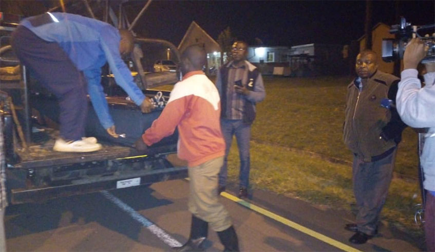 The body of Semukanya Gasore is loaded off a Ugandan Police van. / Courtesy 
