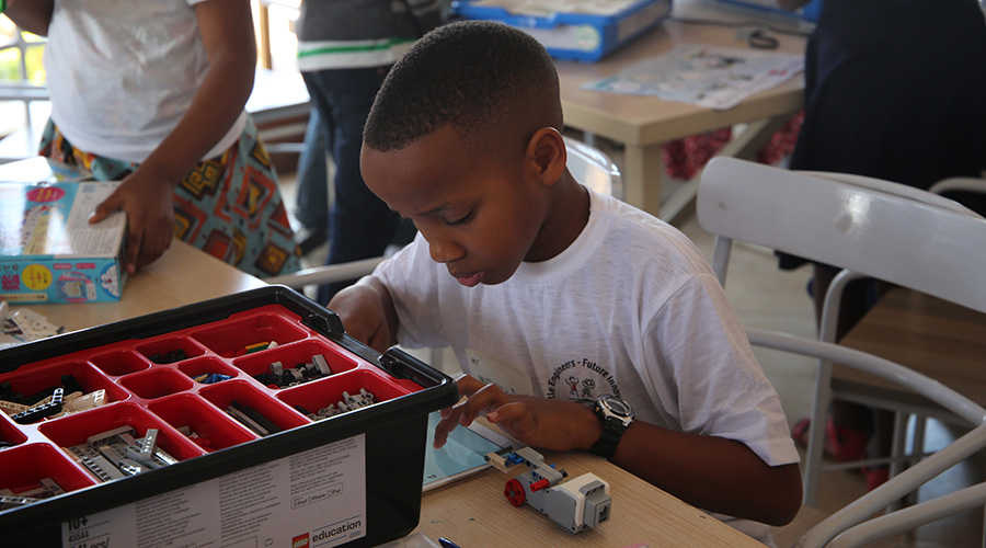 A young boy at the robotics facility. The school will help young children use such technology to come up with ways of solving problems in the society. / Craish Bahizi