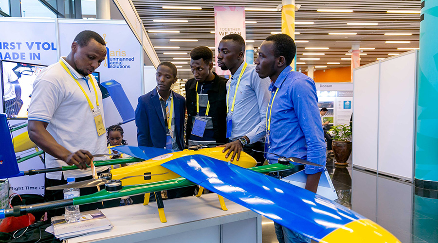 Participants at the African Drone Forum in Kigali look at one of the drones on display. Leapr Labs, a local drones company has signed deals with 3 drone companies and a Dutch University. | Emmanuel Kwizera