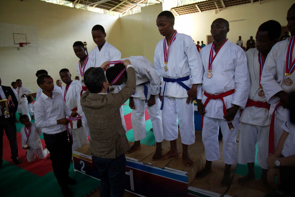 Zen Karate Club players pose for a group photo with officials at LycÃ©e de Kigali gymnasium on Sunday after retaining the title they won in 2019. / Craish Bahizi
