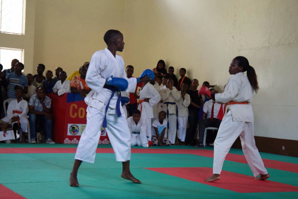 Zen Karate Club players pose for a group photo with officials at LycÃ©e de Kigali gymnasium on Sunday after retaining the title they won in 2019. / Craish Bahizi