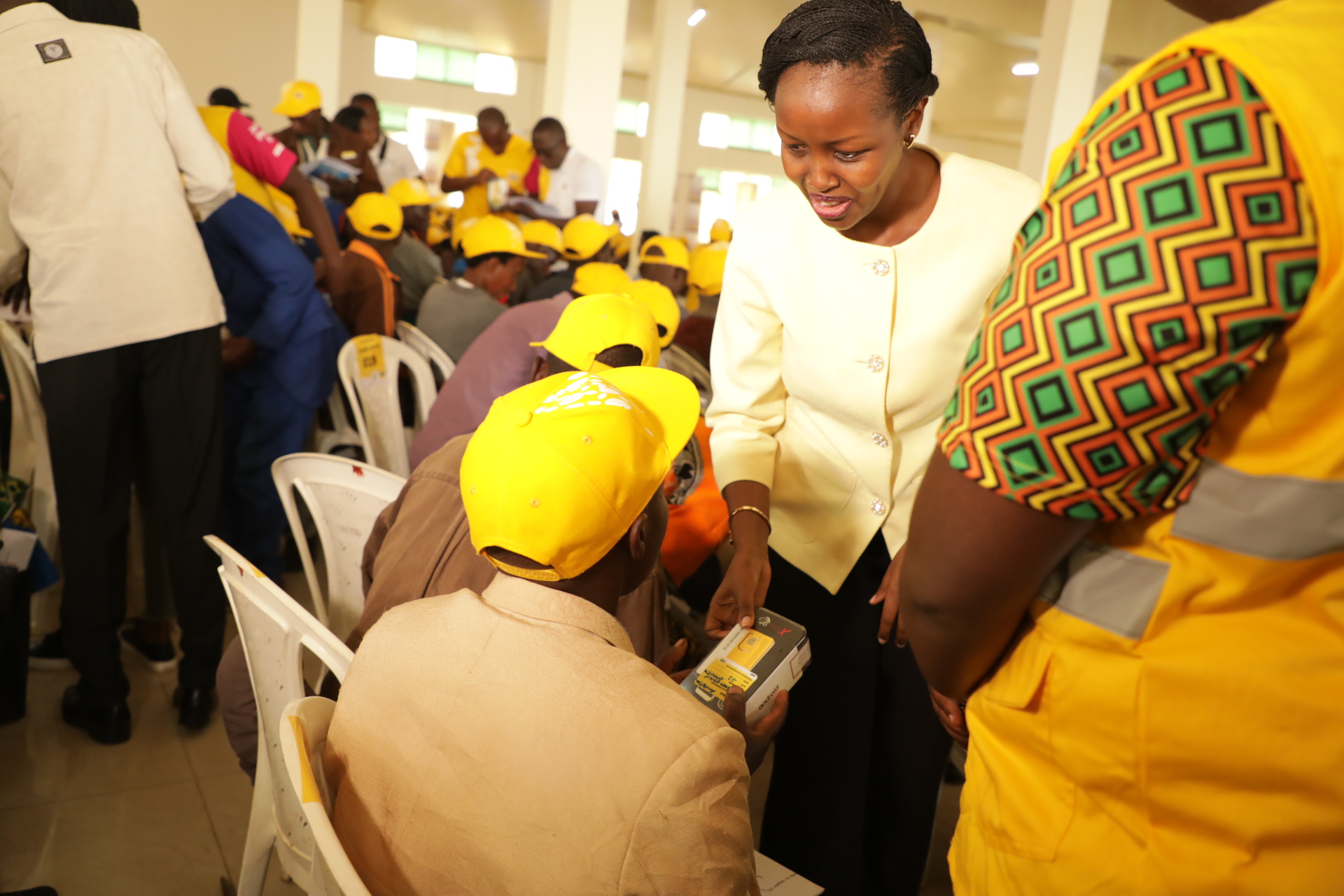 Paula Ingabire (left), the Minister for ICT and Innovation, shows two female residents of Rutsiro District how to use a smartphone on Thursday, February 13. 1000 residents in the district benefited from the Connect Rwanda campaign, which was launched in December last year. / Courtesy photos