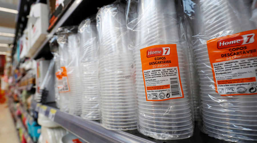 Single-use plastic cups on shelves in a local supermarket. 