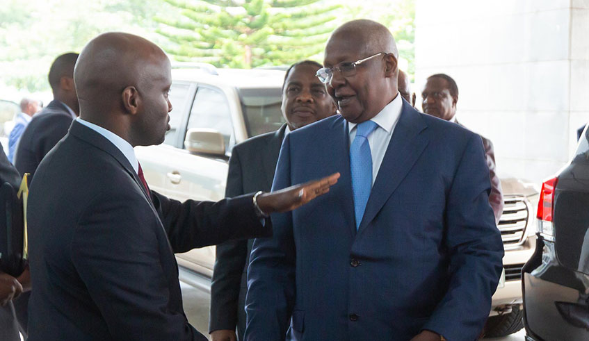 Amb. Olivier Nduhungirehe, the State Minister in charge of East African Community (left), chats with Ugandau2019s Minister for Foreign Affairs Sam Kutesa moments before the start of the third meeting of the Ad Hoc Commission on the implementation of the Luanda Memorandum of Understanding between Rwanda and Uganda aimed at normalising bilateral relations, in Kigali on Friday. The two sides agreed to verify the status of nationals detained in both countries ahead of the next Quadripartite Heads of State Summit, at Gatuna border crossing, on February 21./  Emmanuel Kwizera.