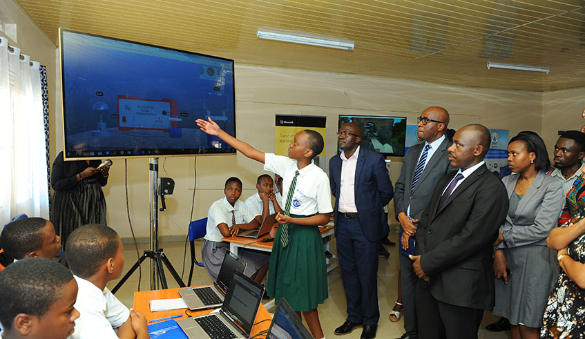 A student demostrates how a Tech-enabled system works to the Minister of Education Dr. Eugene Mutimura, PS Mr. Sam Mulindwa and DG REB, Dr. Irene Ndayambaje at FAWE Girls School in Gasabo District.