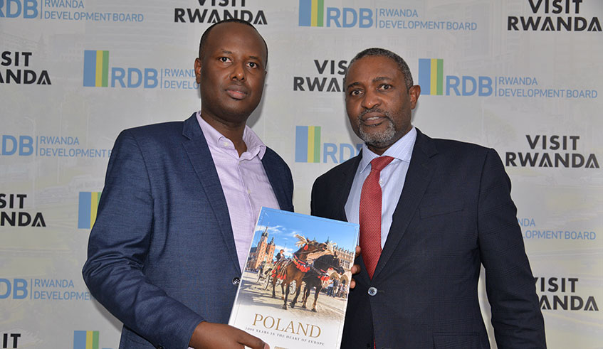 Lucky Philip, Senior Investment Promotion Officer at Rwanda Development Board (L), and Killion Munyama, a Polish MP during the delegationu2019s visit to RDB offices on Tuesday. / Courtesy.