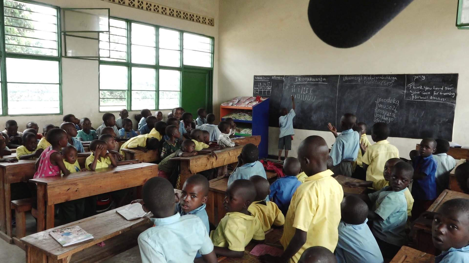 Students of Groupe Scolaire Paysannat L write in their notebooks during a lesson. The Rwanda Education Board says the school is the most overcrowded in Rwanda with almost 24,000 thousand students. / All photos by Glory Iribagiza