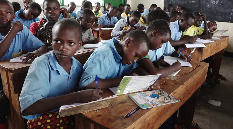 Students of Groupe Scolaire Paysannat L write in their notebooks during a lesson. The Rwanda Education Board says the school is the most overcrowded in Rwanda with almost 24,000 thousand students. / All photos by Glory Iribagiza