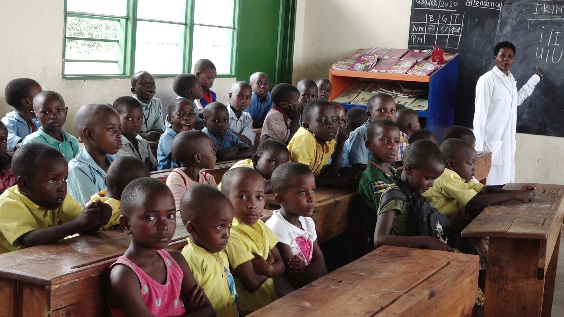 Students of Groupe Scolaire Paysannat L write in their notebooks during a lesson. The Rwanda Education Board says the school is the most overcrowded in Rwanda with almost 24,000 thousand students. / All photos by Glory Iribagiza