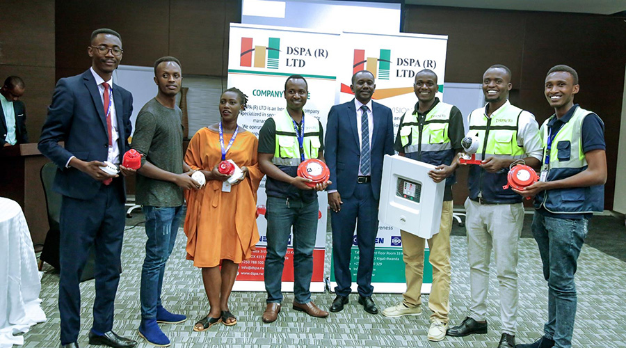 DSPA CEO, John Gatebera (centre) together with DSPA team pose for a group photo displaying some of the equipment used for installation of fire and security systems. / Courtesy
