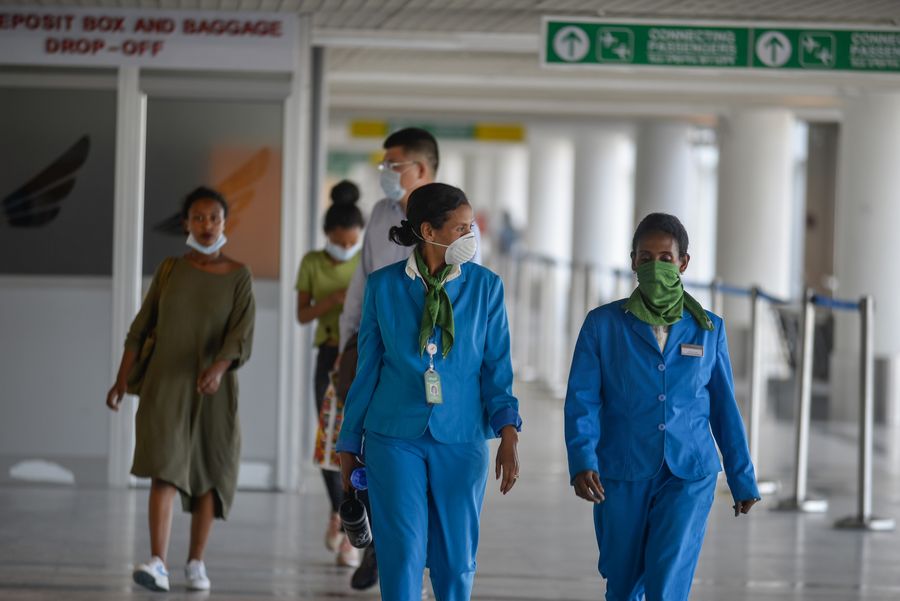 People wear protective face masks at Bole International airport in Addis Ababa on Jan. 30, 2020. 