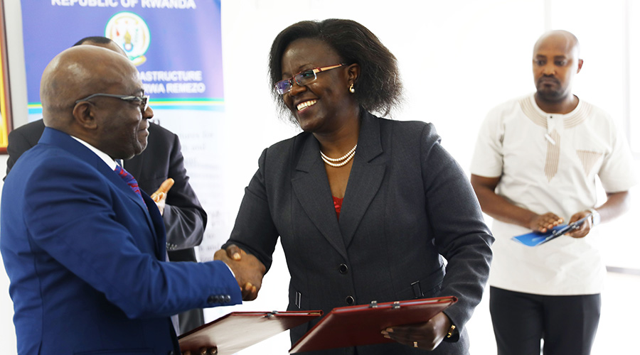 Rubens Mikindo Muhima, DR Congou2019s State Minister in charge of Hydrocarbons (left), and Rwandau2019s Minister for Environment Jeanne du2019Arc Mujawamariya exchange documents after signing the agreement under which both countries will monitor safe exploitation of methane gas and protect biodiversity in Lake Kivu. 
