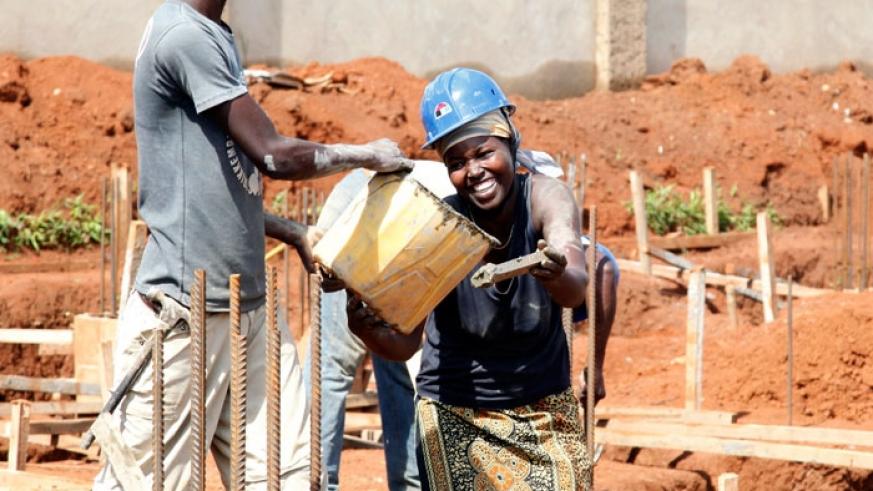A male and female workers at a construction site in Kigali. 