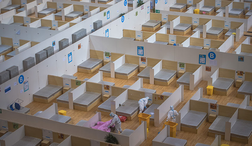 Staff members clean up a closed makeshift hospital in Wuhan, central China's Hubei Province, March 8, 2020. (Xinhua/Xiao Yijiu)
