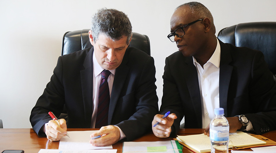 Rwanda Energy Group chief executive Ron Weiss (left) consults with Felix Gakuba, the Managing Director of Energy Development Corporation, during  the meeting with parliamentary committee on Tuesday. 
