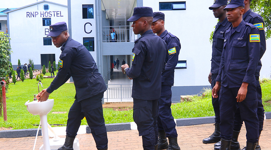 Police officers wash hands before accessing their hostel. 