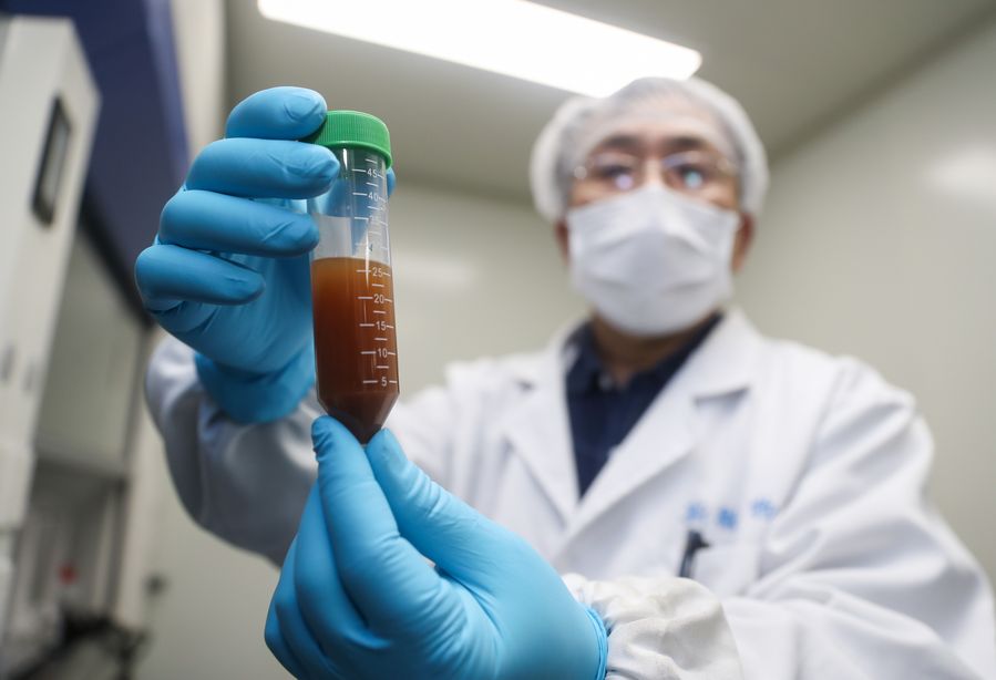 A researcher shows the experiment to develop an mRNA vaccine targeting the novel coronavirus in east China's Shanghai, Jan. 29, 2020. 