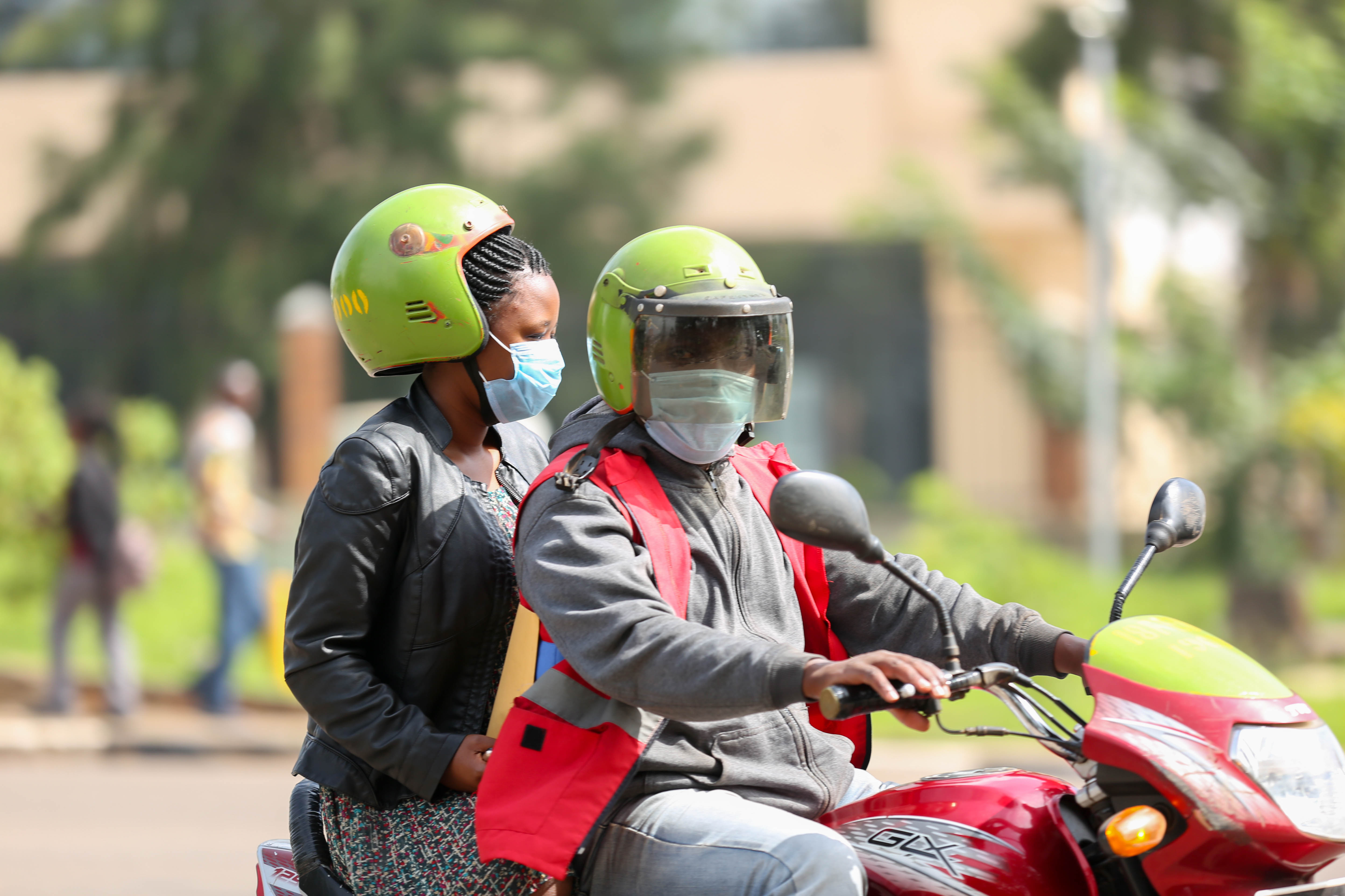 A mobile money agent and his clients wear facemasks in Kigali yesterday (Craish Bahizi)