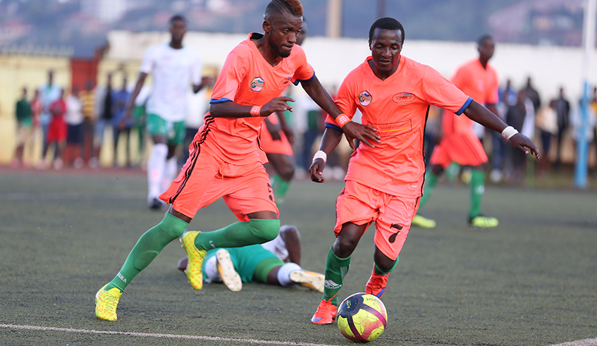 Gicumbi FC players protect the ball during a league match against SC Kiyovu at Umumena Stadium. / Sam Ngendahimana.