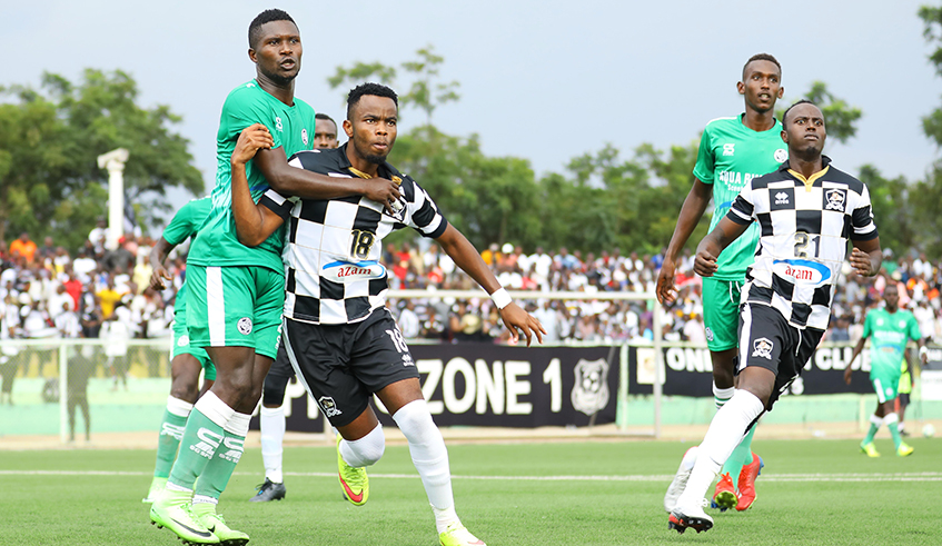 SC Kiyovu and APR FC players vie for the ball during a league match at Kigali stadium. Due to COVID-19 sports competitions have been suspended. / Sam Ngendahimana.