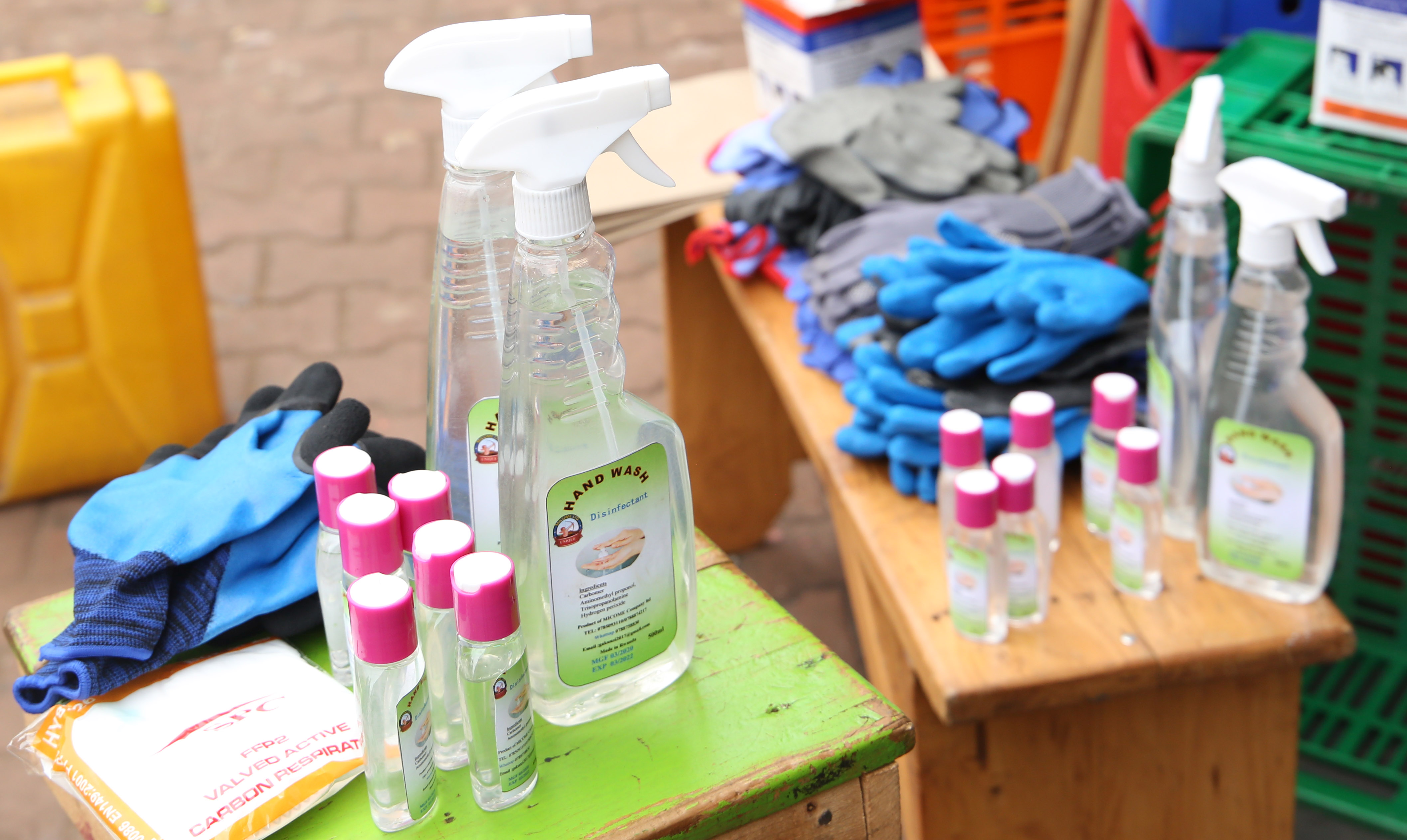 A mobile money agent and his clients wear facemasks in Kigali yesterday (Craish Bahizi)