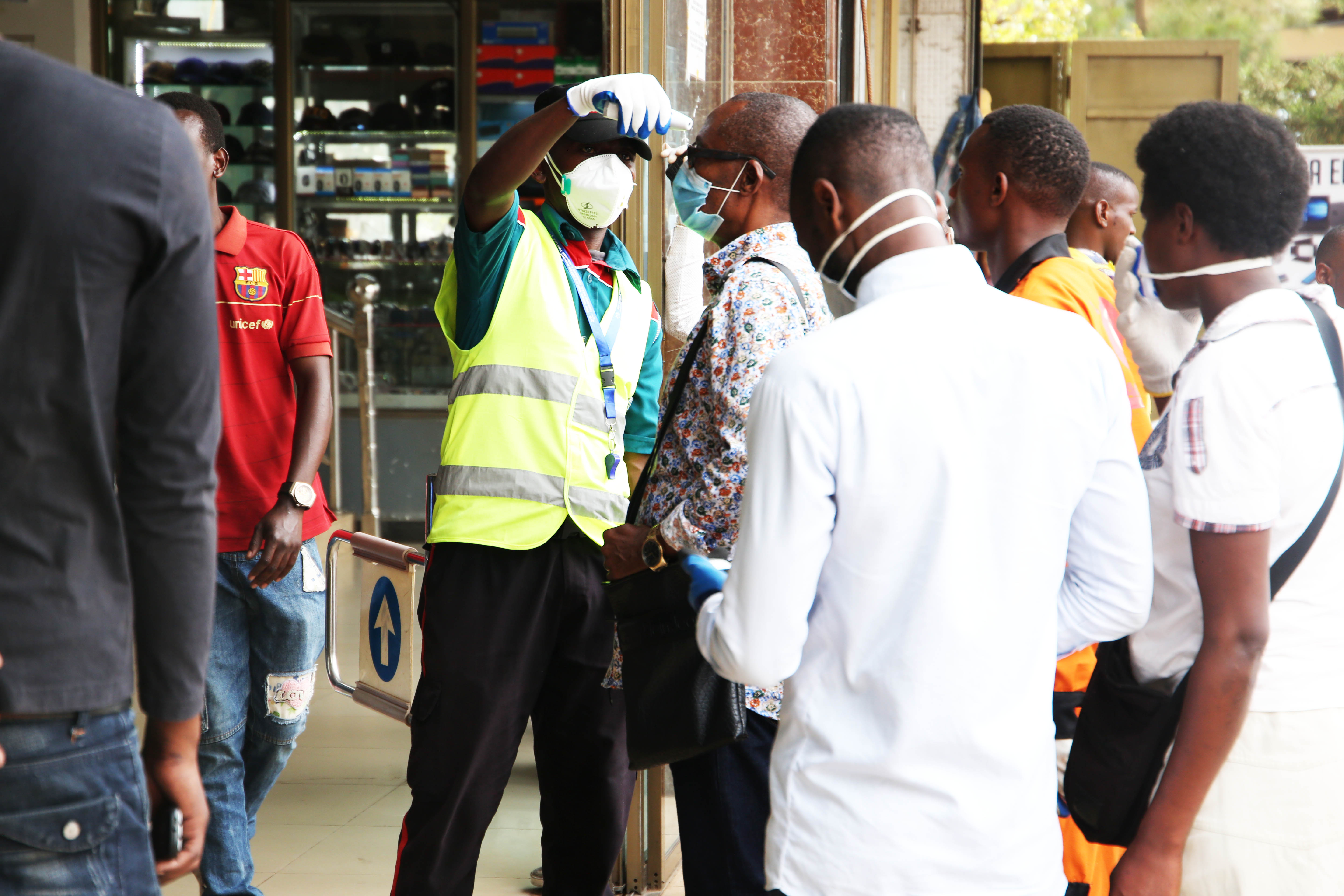 A mobile money agent and his clients wear facemasks in Kigali yesterday (Craish Bahizi)