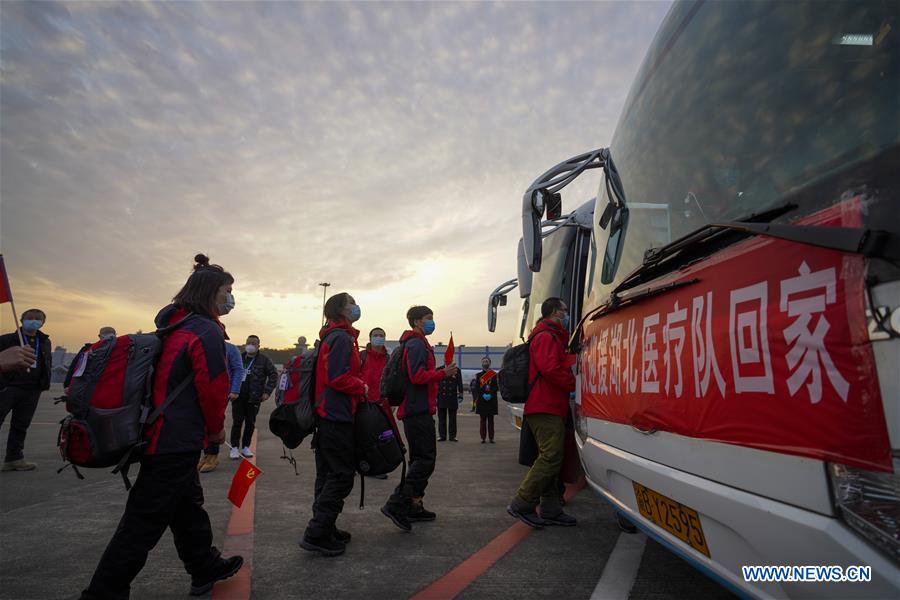 Medics supporting virus-hit Hubei Province take buses after arriving at Chongqing Jiangbei International Airport in southwest China's Chongqing, March 18, 2020. Medical assistance teams started leaving Hubei Province as the epidemic outbreak in the hard-hit province has been subdued. 