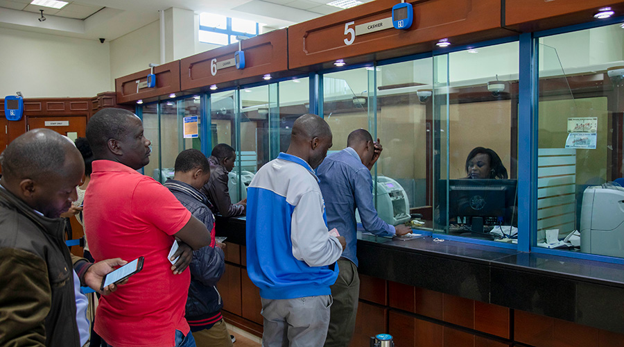 Clients queue in a banking hall of one of the commercial banks in the country. Local banks have adopted a number of measures to help reduce physical contact as the country steps efforts to curb the spread of COVID-19. 