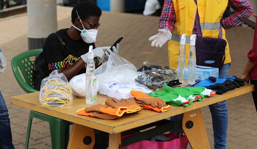 A woman retailing hand sanitizers, gloves and face masks at Kigali Downtown Bus Park on Tuesday, March 17. The demand for such products has significantly increased as Rwandans try to keep the global pandemic of coronavirus (COVID-19) at bay. COMESA has warned traders in fake sanitary products as part of the global effort to curb the virus. / Photo: Craish Bahizi.