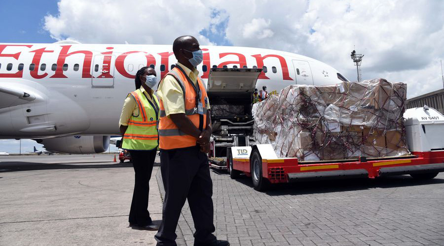 Kenya Airport Authority workers look on as a consignment of medical equipment donation for COVID-19 that was donated by Jack Ma and Alibaba Foundations to Kenya is offloaded from an Ethiopian Airline Plane at Jomo Kenyatta International Airport in Nairobi, Kenya, on March 24, 2020. 