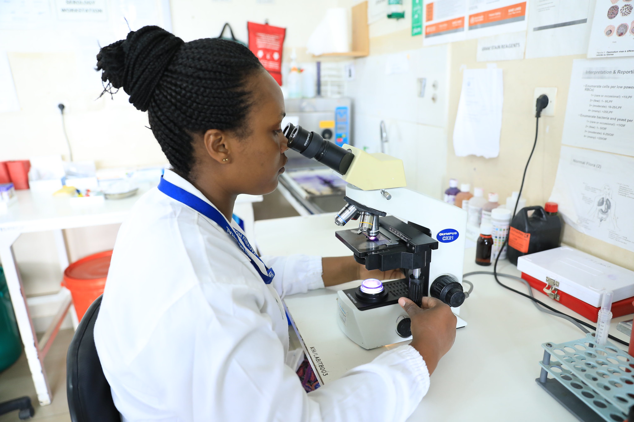 A lab technician examining tests at a clinic in Kigali. 