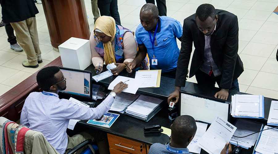 Bank of Kigali staff help some new customers to open accounts at the head office. 