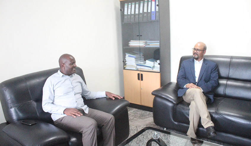 Rubavu District mayor Gilbert Habyarimana (Left) and the Pfunda Tea Company Managing Director, Surender Jhijaria chat during a function to hand over the funds meant to support vulnerable resident from the district. / Ru00e9gis Umurengezi