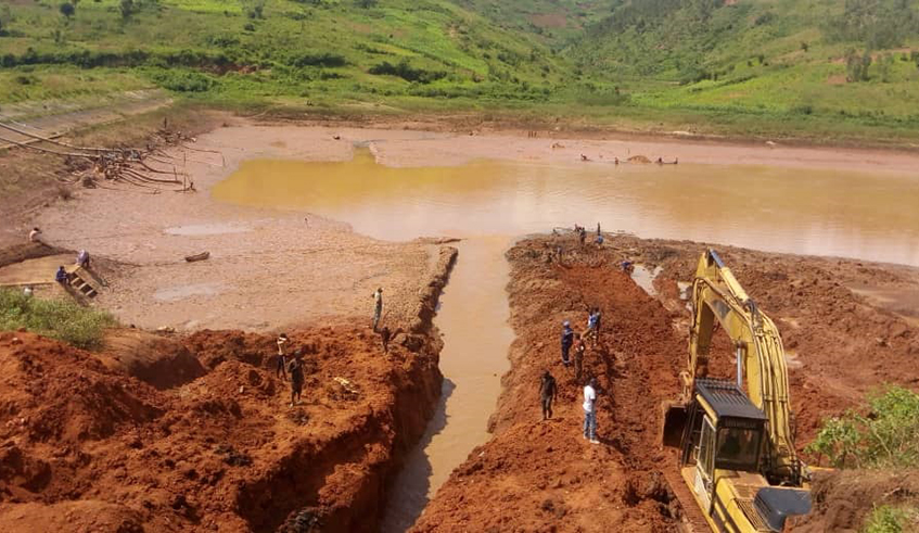 Draining of water from a valley dam in Kayonza District will be complete by Friday, paving way for the process to exhume the remains of Genocide victims from the dam. Courtesy.