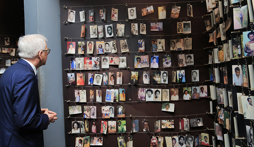 A visitor looks at pictures of the victims of 1994 Genocide against the Tutsi archived inside Kigali Genocide Memorial. / Sam Ngendahimana.