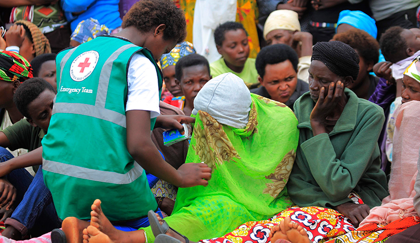 A volunteer helps a trauma victim during a past commemoration event at Murambi Genocide Memorial in Nyamagabe District. / Photo: Sam Ngendahimana.