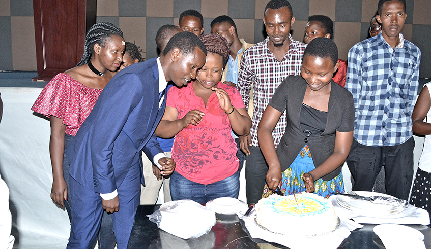 Mizero (left) and some of the youth that benefit from the work of his organisazion celebrate one of the member's birthday party. / Courtesy.