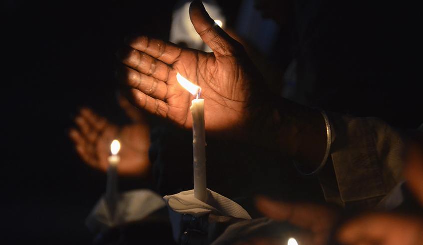 Mourners hold candles during a vigil in honour of Genocide victims in Kimihurura last year. / Photo: Sam Ngendahimana.