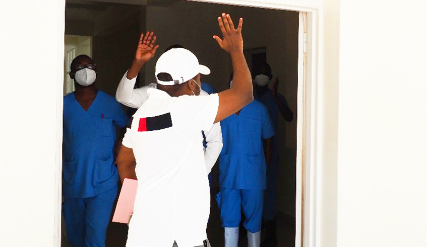 One of four people who were discharged from a novel coronavirus treatment centre salutes staff of the facility before leaving on Sunday  (1).Three more people were discharged today. / File