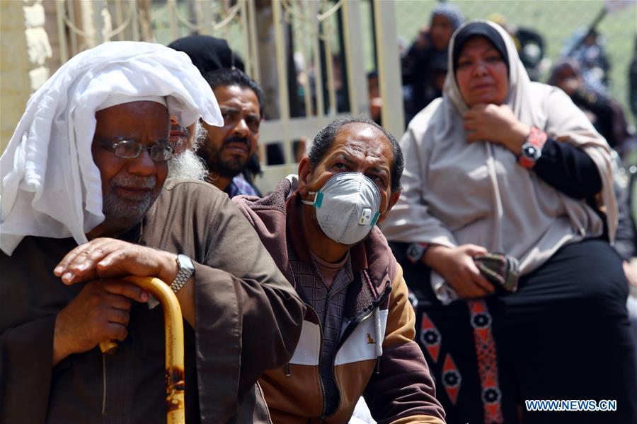 A senior citizen wearing a face mask waits to receive his pension at a youth center on the outskirts of northern Cairo, Egypt, on April 8, 2020. The Egyptian Health Ministry reported on Wednesday 110 new cases and nine deaths of COVID-19, raising the total number of cases in the country to 1,560, including 103 deaths. 