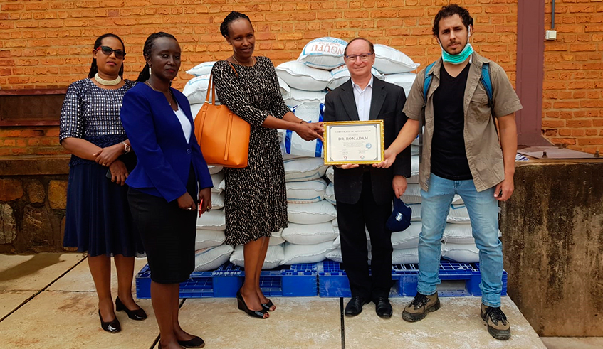 Amb. Ron Adam (2nd right) handed over the supplies to officials at the government stores located in Kicukiro District. / Photo: Courtesy.