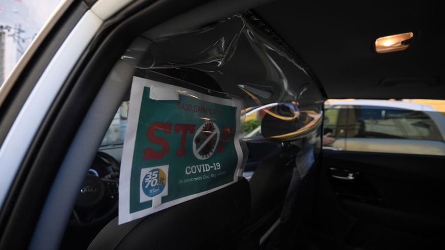 Protective plastic barrier and a sanitation certification are seen in a taxi in Rome, Italy, April 16, 2020. (Photo by Alberto Lingria/Xinhua)