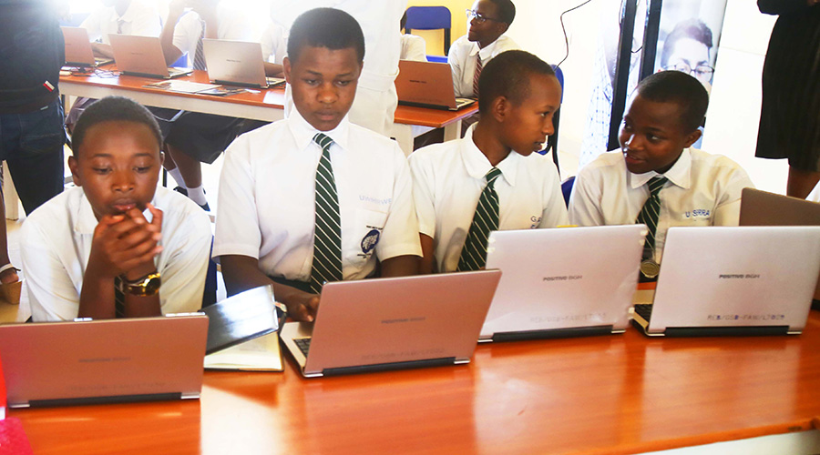 Students during their ICT teamwork at FAWE Girls School in February. Currently students follow lessons online. 