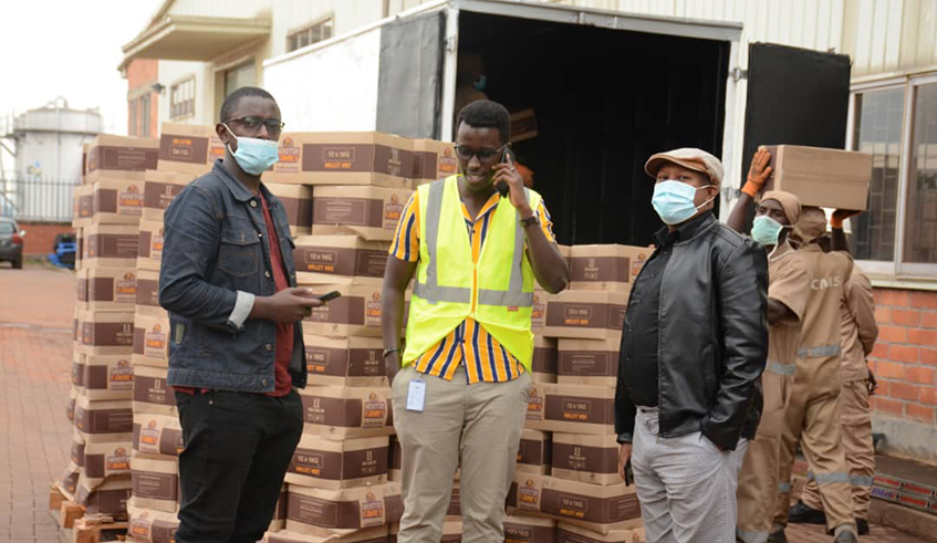  RSJF president Joel Rutaganda (L), AIF official and music promoter Alex Muyoboke (R) during the distribution exercise. / Courtesy.
